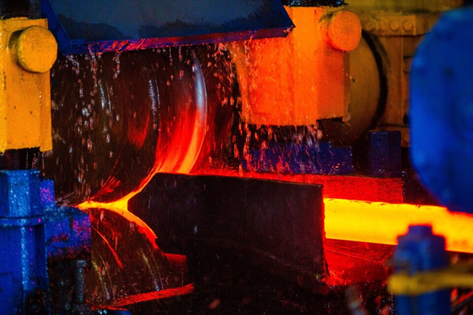 Molten steel being poured into a mold in a steel mill