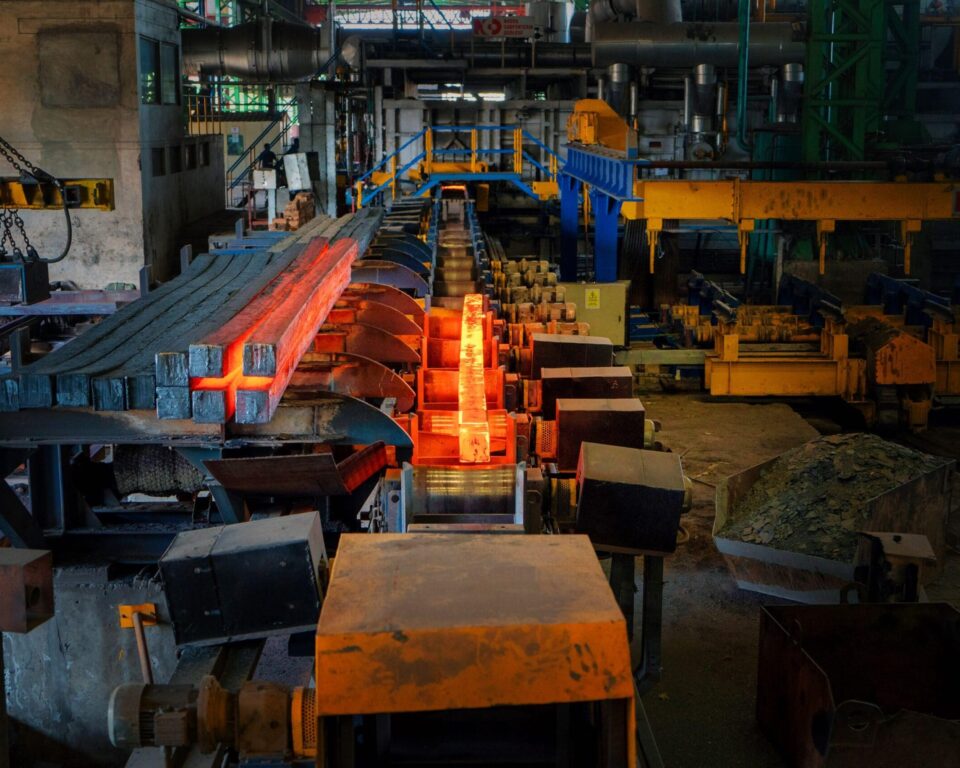 A modern steel manufacturing plant with towering structures and smokestacks